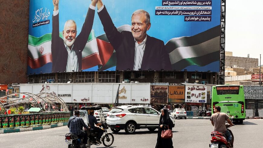 A billboard in Tehran showing Iranian President Masoud Pezeshkian (R) and late Hamas leader Ismail Haniyeh