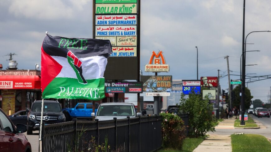 Palestinian flags flutter in the wind, shops display signs in both Arabic and English, and posters call for demonstrations against steadfast US military support of Israel 