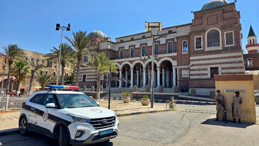 Police officers stand guard outside Libya's central bank headquarters in Tripoli