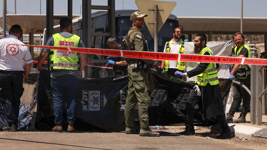 Israeli troops and medics respond after a Palestinian is shot dead at a checkpoint outside Jerusalem following an alleged stabbing attack on a border police officer