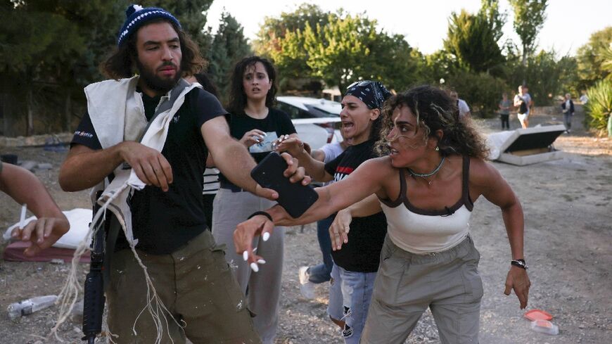 Activists confront a settler (left) near the occupied West Bank village of Beit Jala