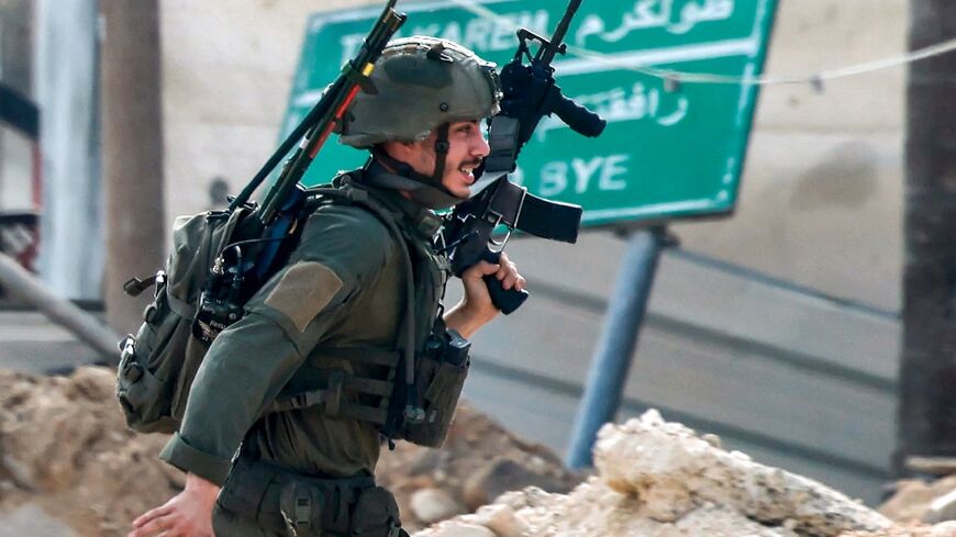 An Israeli soldier takes position during a raid on the West Bank city of Tulkarem on the second day of a major military operation in the north of the occupied territory