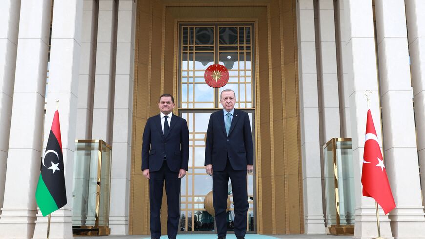 Turkish President Recep Tayyip Erdogan (R) and Libyan government of national unity prime minister Abdul Hamid Dbeibah (L) pose for a photo during the official ceremony prior to their meeting in Ankara on April 12, 2021. (Photo by Adem ALTAN / AFP) (Photo by ADEM ALTAN/AFP via Getty Images)