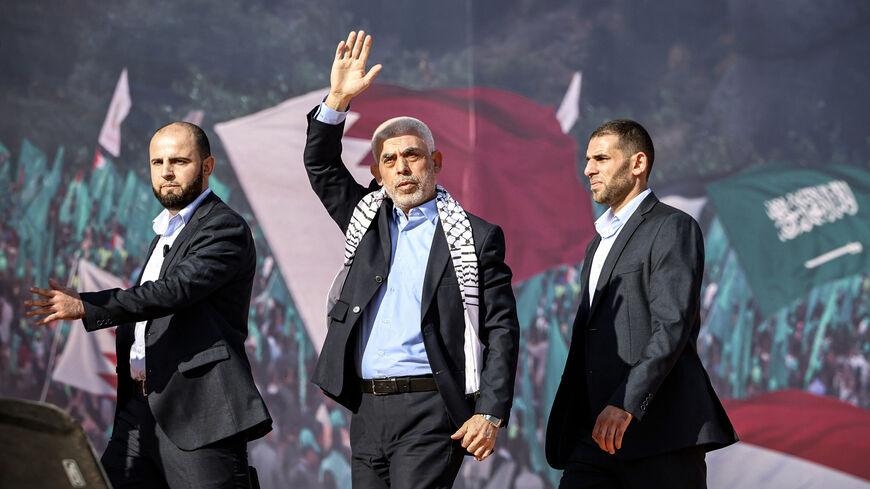 Yahya al-Sinwar (C), Gaza Strip chief of the Palestinian Islamist Hamas movement, waves to supporters during a rally marking the 35th anniversary of the group's foundation, in Gaza City on December 14, 2022. Hamas will end talks on securing a prisoner exchange with Israel unless there is progress soon, the militant group's leader in the Gaza Strip said on December 14. Since Israel's 2014 invasion of the Gaza Strip, the Islamist group has held the bodies of Israeli soldiers Oron Shaul and Hadar Goldin, altho