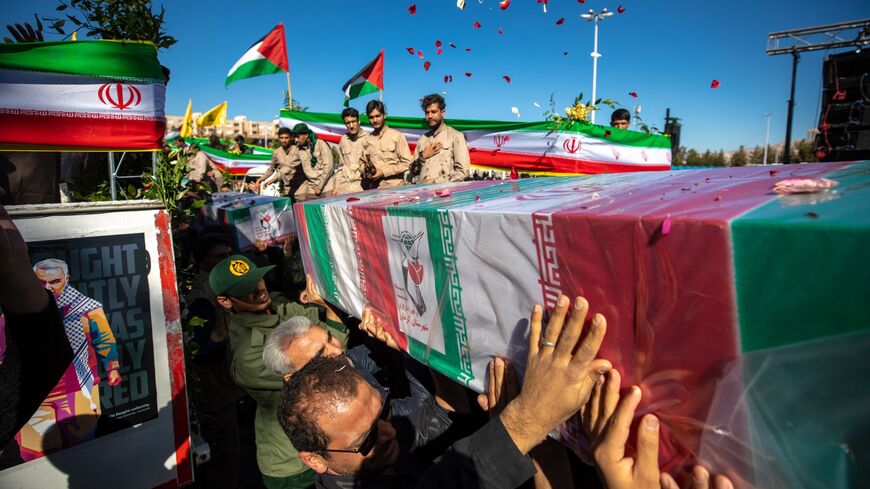  Iranian mourners carry coffins of the victims of a suicide bombing, Kerman, Iran, Jan. 5, 2024.