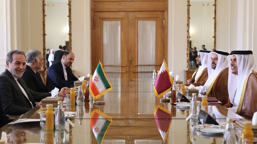 Iran's new foreign minister, Abbas Araghchi (L), meets with Qatari Prime Minister Sheikh Mohammed bin Abdulrahman Al Thani (R) in Tehran, on Aug. 26, 2024.