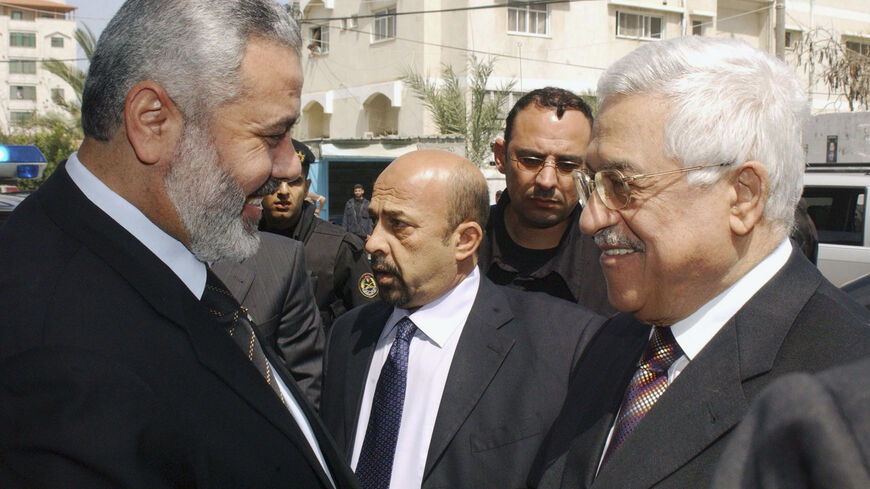 In this handout image supplied by the Palestinian Press Office (PPO), Palestinian Prime Minister Ismail Hanyeh smiles with Palestinian President Mahmoud Abbas, outside Haniyeh's office before holding talks on April 5, 2007 in Gaza, Gaza Strip. Haniyeh today meet with British Consul General in Jerusalem, Richard Mikbis, to discuss the kidnapping of BBC journalist Alan Johnston who went missing on March 12, 2007. (Photo by Abu Askar/PPO via Getty Images)