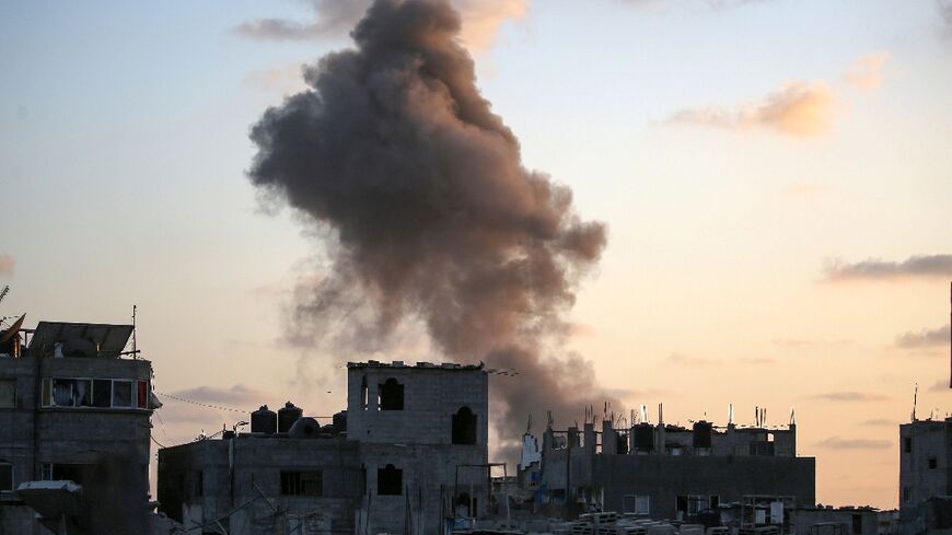 Smoke rises as Israeli troops target a building in Nuseirat refugee camp, central Gaza