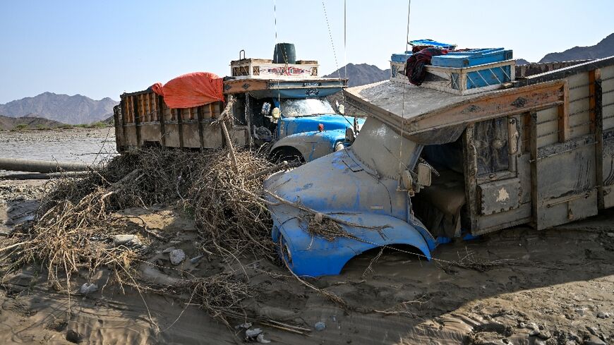 Damaged trucks burried in the mud after the collapse of the Arbaat Dam in northeast Sudan