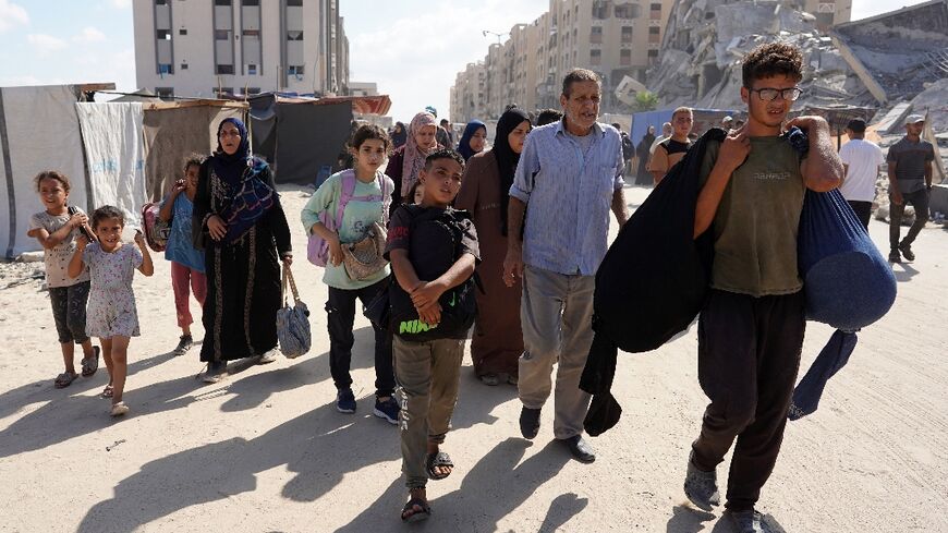 Palestinians families flee the Hamas neighbourhood in Khan Yunis following a new Israeli evacuation order