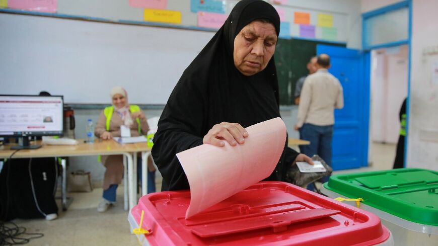 A Jordanian woman votes at a polling station in the Al-Baqaa Palestinian refugee camp near the capital Amman