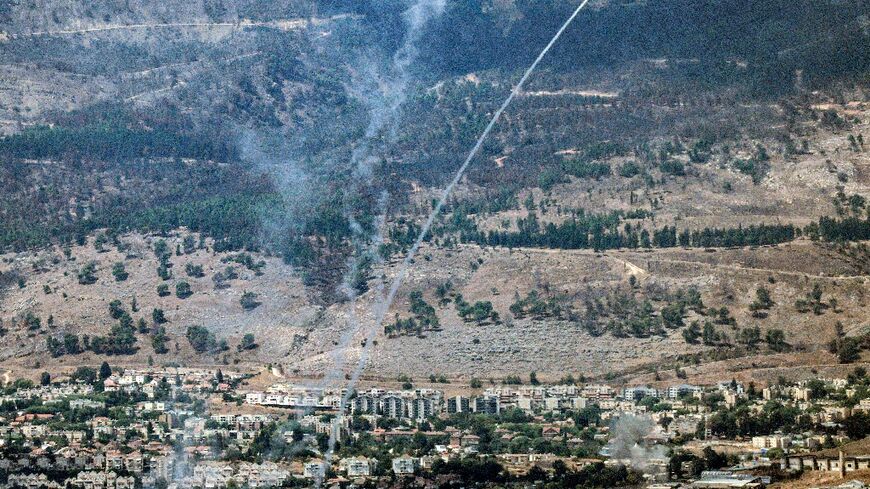 Rockets fired from southern Lebanon are intercepted by Israel's Iron Dome air defence system over the Upper Galilee region in northern Israel on September 4, 2024