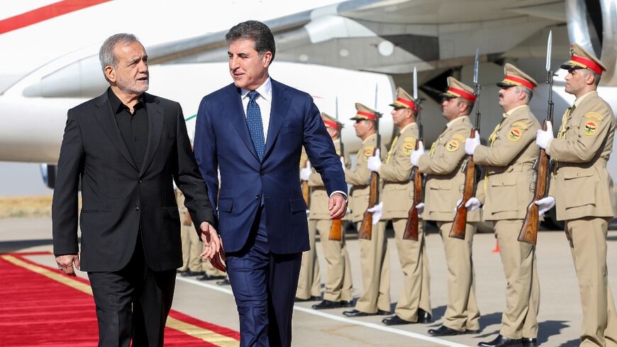 The president of Iraq's autonomous Kurdistan region, Nechirvan Barzani, welcomes Iran's President Masoud Pezeshkian at Arbil airport