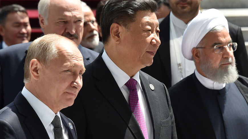 Russian President Vladimir Putin, Chinese President Xi Jinping and Iran's President Hassan Rouhani walk as they attend a meeting of the Shanghai Cooperation Organisation (SCO) Council of Heads of State in Bishkek on June 14, 2019. (Photo by Vyacheslav OSELEDKO / AFP) (Photo credit should read VYACHESLAV OSELEDKO/AFP via Getty Images)