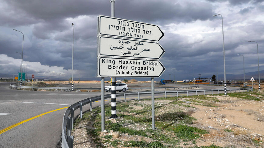 A car drives past a road signal indicating the Allenby (King Hussein) Bridge crossing point to Jordan (background), Jericho, West Bank, Jan. 28, 2021.