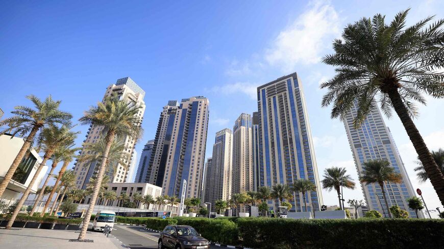 Cars drive along a street in front of high-rise buildings in Dubai, on February 18, 2023. - Home to towering skyscrapers and ultra-luxury villas, Dubai saw record real estate transactions in 2022, largely due to an influx of wealthy investors, especially from Russia. (Photo by Karim SAHIB / AFP) (Photo by KARIM SAHIB/AFP via Getty Images)