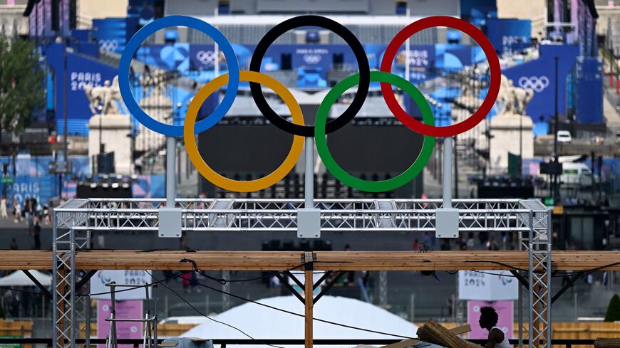 The Olympic rings are seen during preparation works at the Eiffel Tower stadium in Paris on July 24, 2024, ahead of the Paris 2024 Olympic Games.