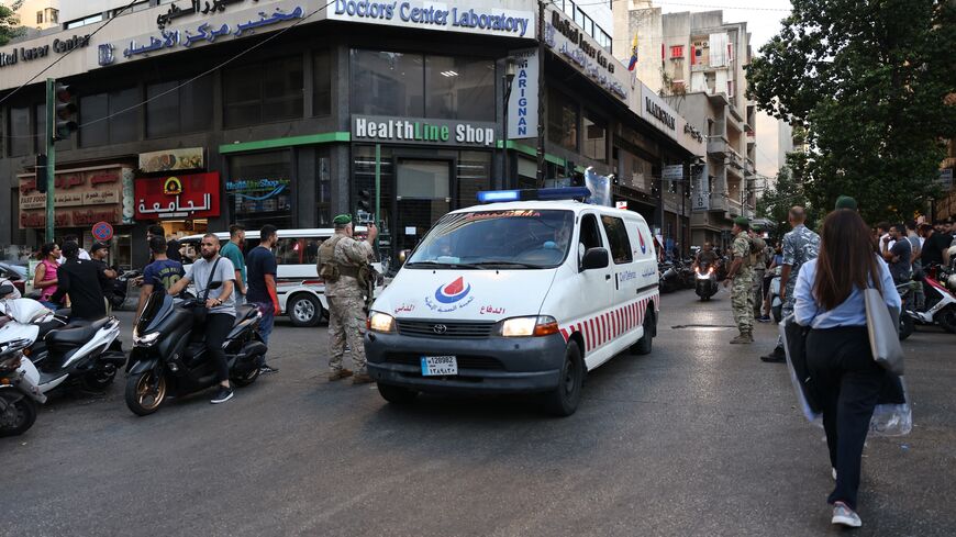 Lebanese army soldiers stand guard as an ambulance rushes wounded people to a hospital in Beirut on Sept. 17, 2024.