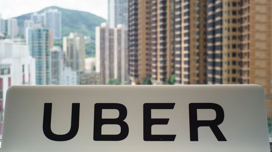 A sign with an Uber logo is seen in the smartphone ride-hailing giant's office in Hong Kong on July 13, 2017.