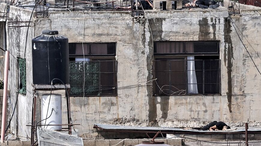 The bodies of three men killed during an Israeli army raid lie on the roof of a building, and just below it, in Qabatiya near Jenin in the occupied West Bank 