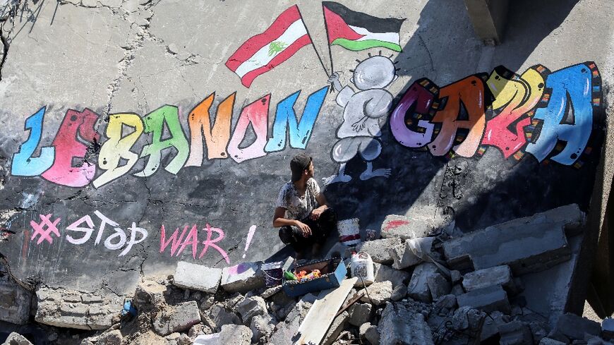 A Palestinian artist has painted a mural on the remains of a flattened Gaza building, in a message of solidarity with Lebanon