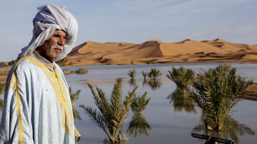 A local man poses for a picture at Yasmina Lake, a seasonal lake in the village of Merzouga in the Sahara desert in southeastern Morocco