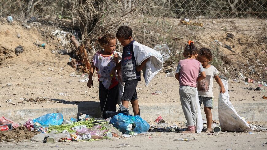 Palestinian children salvage items from garbage central Gaza