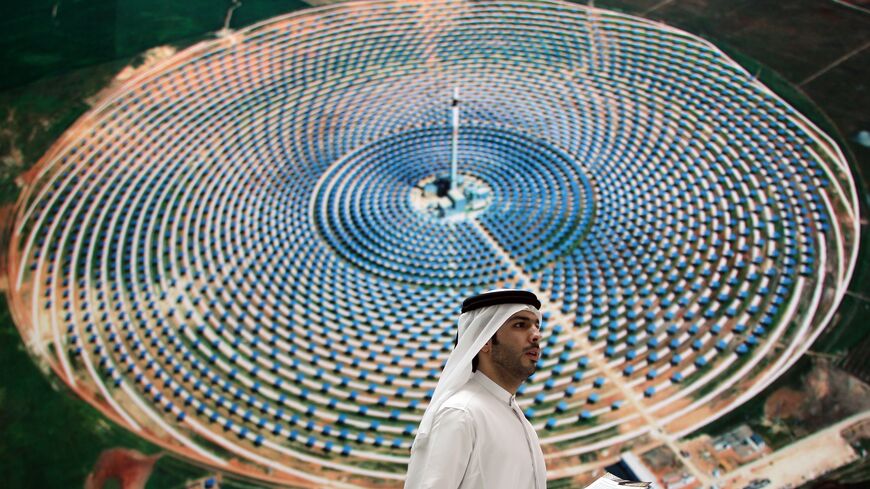 An Emirati man walks in front of the stand of Masdar City at the World Future Energy Summit exhibition in Abu Dhabi on Jan. 18, 2012.