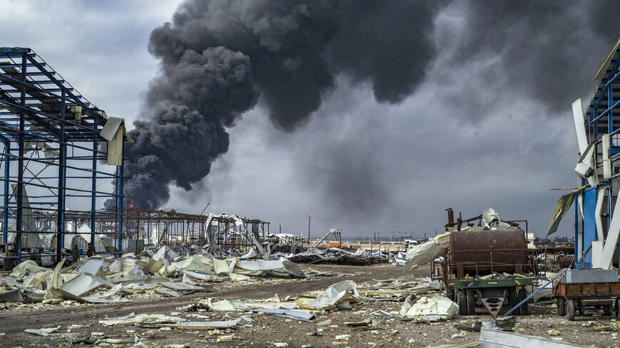 Thick smoke billows from a raging fire at a storage tank of the al-Awda oil field facility near al-Qahtaniyah in northeastern Syria close to the Turkish border on Dec. 24, 2023, a day after a reported Turkish strike. 