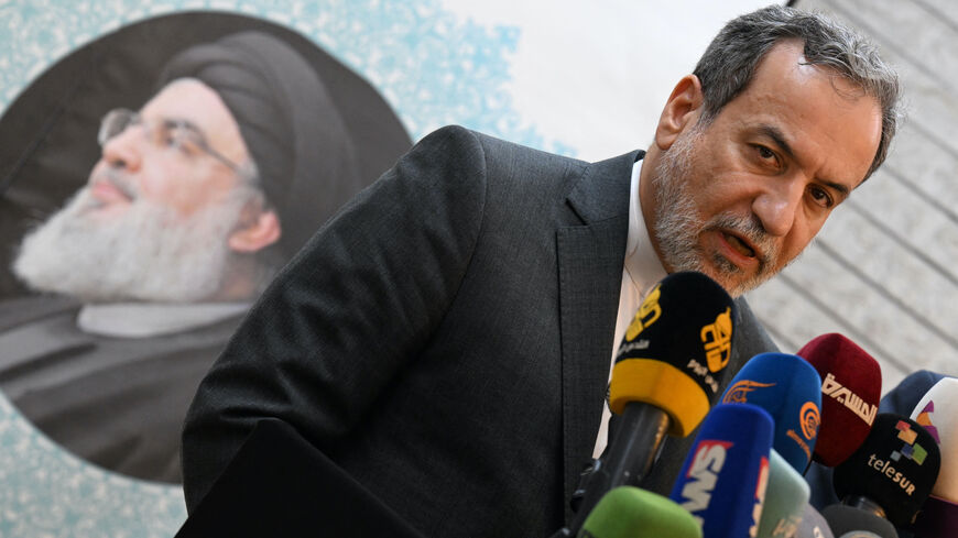 Iranian Foreign Minister Abbas Araghchi speaks to the press, in front of the portrait of slain Lebanese Hezbollah leader Hassan Nasrallah, after meeting with Syrian officials at the Iranian embassy in Damascus on Oct. 5, 2024. 