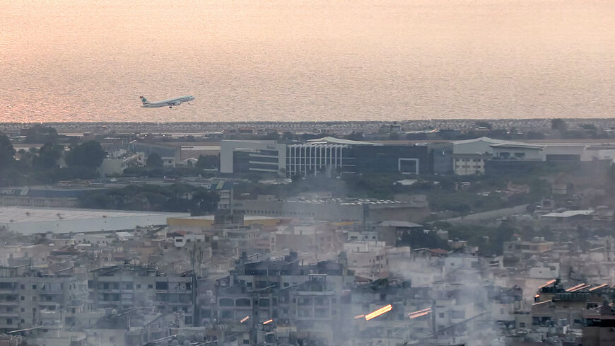 An aircraft of Middle East Airlines (MEA), Lebanon's flag carrier, takes off from Beirut International Airport on Oct. 6, 2024 amidst smoke rising from nearby sites targeted overnight by Israeli air strikes in the southern suburbs of the Lebanese capital. 