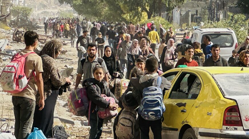 Displaced families fleeing Israeli army operations in Jabalia in northern Gaza take the main Salah al-Din road toward Gaza City on Oct. 23, 2024.