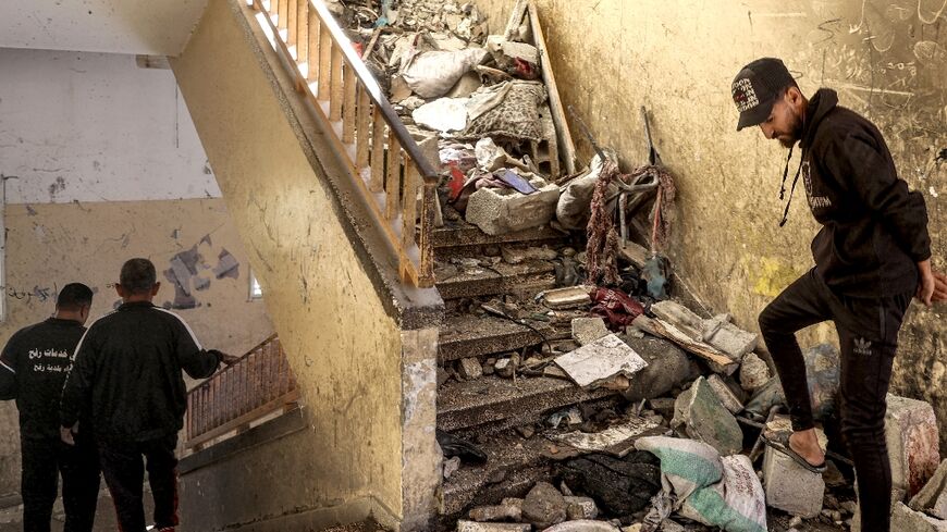 A stairwell littered with rubble and debris in central Gaza's Al-Shuhada school, which was hit by Israeli bombardment