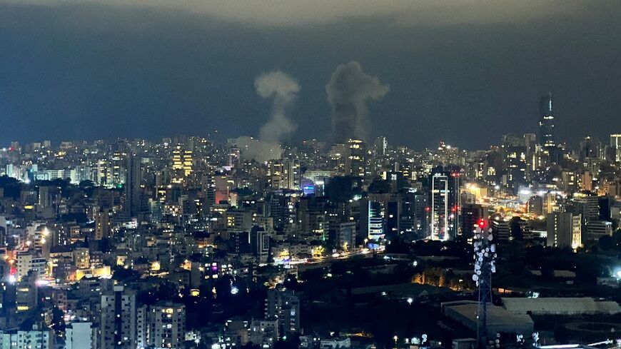 Smoke plumes rise from the site of two Israeli air strikes in the central area of Beirut