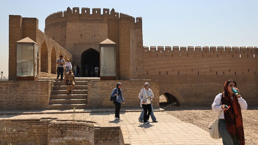 Iraqi students walk through Bab al-Wastani on a walking tour of the historic centre of Baghdad