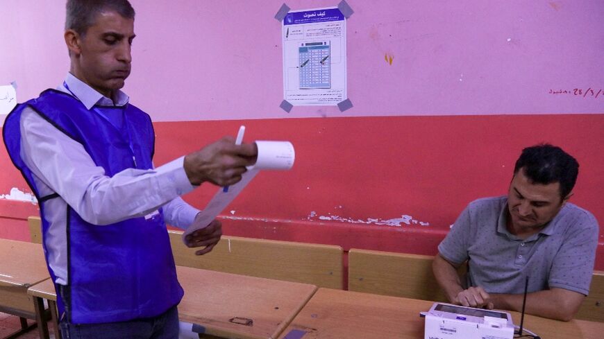 Electoral commission workers count votes at the end of the parliamentary election in Iraq's autonomous Kurdistan region