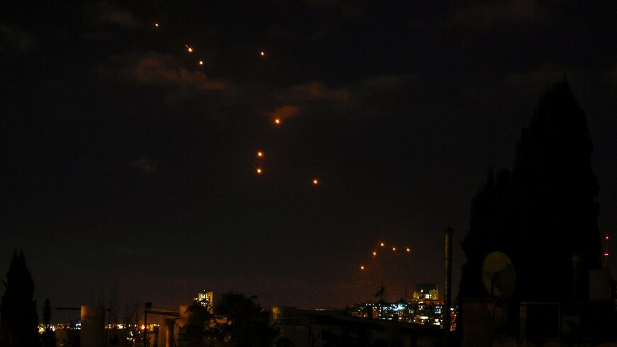 Projectiles streak across the night sky above Jerusalem during the Iranian attack