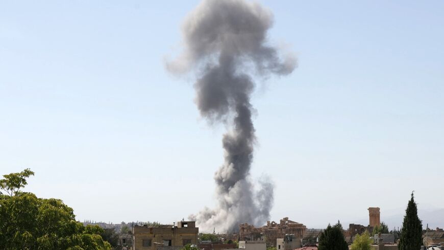 Smoke billows following an Israeli airstrike near the ruins of the ancient Roman Temple of Baachus in Lebanon's eastern city of Baalbek in the Bekaa valley