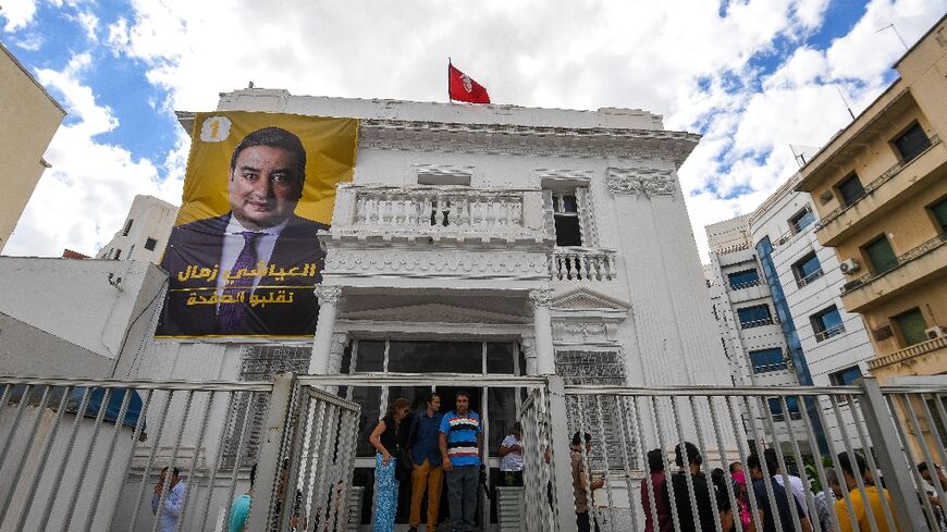 A poster of imprisoned Tunisian presidential candidate Ayachi Zammel is displayed at his electoral headquarters in Tunis