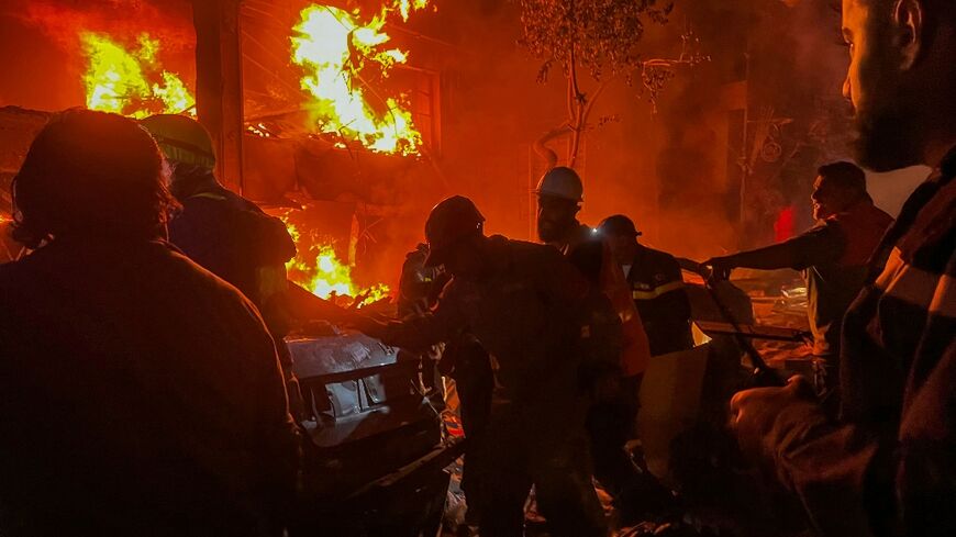 Emergency services fight flames at the site of the Israeli strike on central Beirut