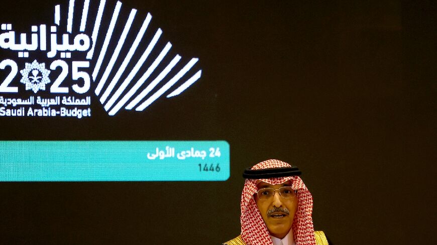 Saudi Finance Minister Mohammed al-Jadaan unveils the kingdom's budget for 2025 at a news conference in Riyadh.