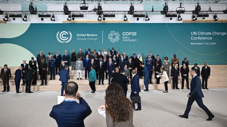 Leaders and delegates arrive for a family photo during the United Nations Climate Change Conference (COP29) in Baku on November 12, 2024