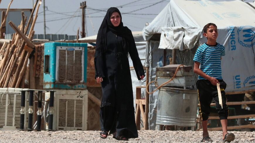 A woman and a boy in the camp near Hassan Shami for the internally displaced