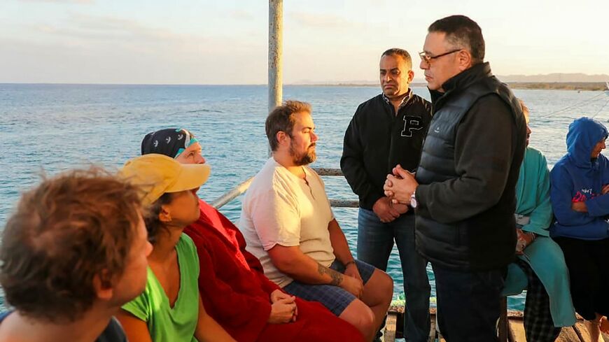 A picture released by the Egyptian State Information Service shows Red Sea governor Amr Hanafi speaking to survivors in Marsa Alam