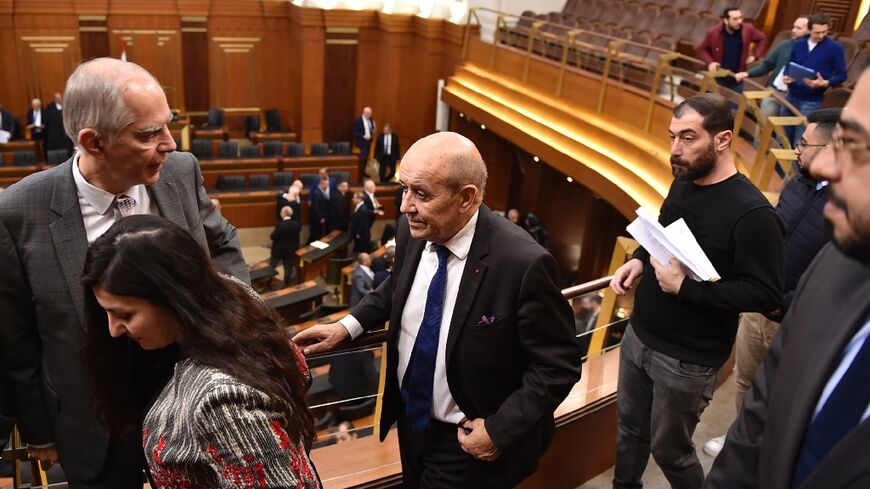 France's envoy to Lebanon Jean-Yves Le Drian (C) and France's ambassador to Lebanon Herve Magro (L), arrive for a parliamentary session at the Lebanese parliament in Beirut