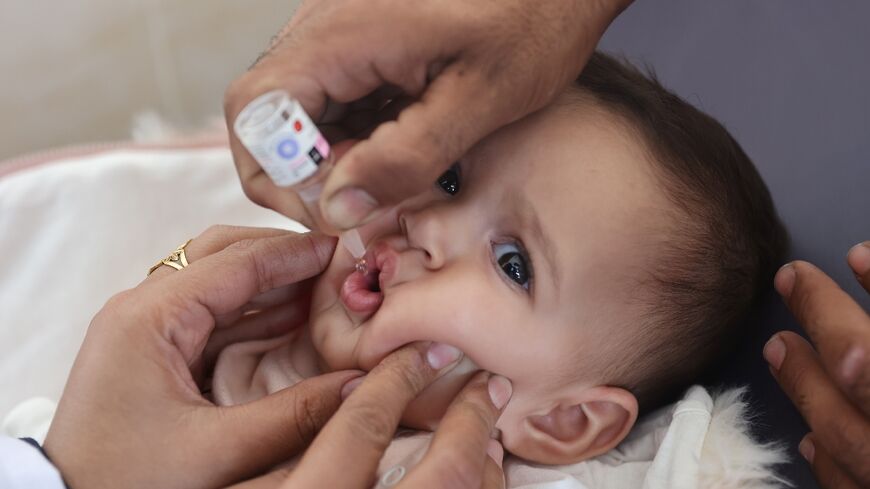 A Palestinian child is vaccinated against polio at Abdel Aziz Rantissi hospital in Gaza City on November 2