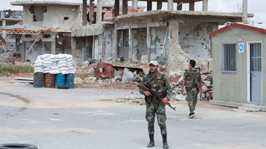 A picture taken during a tour organized by the Syrian Ministry of Information shows Syrian soldiers at a checkpoint in the district of Daraa al-Balad of Syria's southern city of Daraa, on Sept. 12, 2021. 