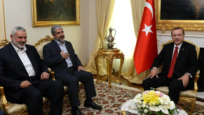 Turkish Prime Minister Recep Tayyip Erdogan (R) poses beside Khalid Mashaal (C), the Hamas chief in exile, and Gaza's prime minister Ismail Haniyeh prior to their meeting in Ankara on June 18, 2013. Senior leaders of the Palestinian Islamist movement Hamas met today in Ankara with Turkish Prime Minister Erdogan to discuss Erdogan's planned visit to the Gaza Strip as well as the situation in Syria, the source said on condition of anonymity. AFP PHOTO/ PRIME MINISTER PRESS OFFICE/ YASIN BULBUL == RESTRICTED T