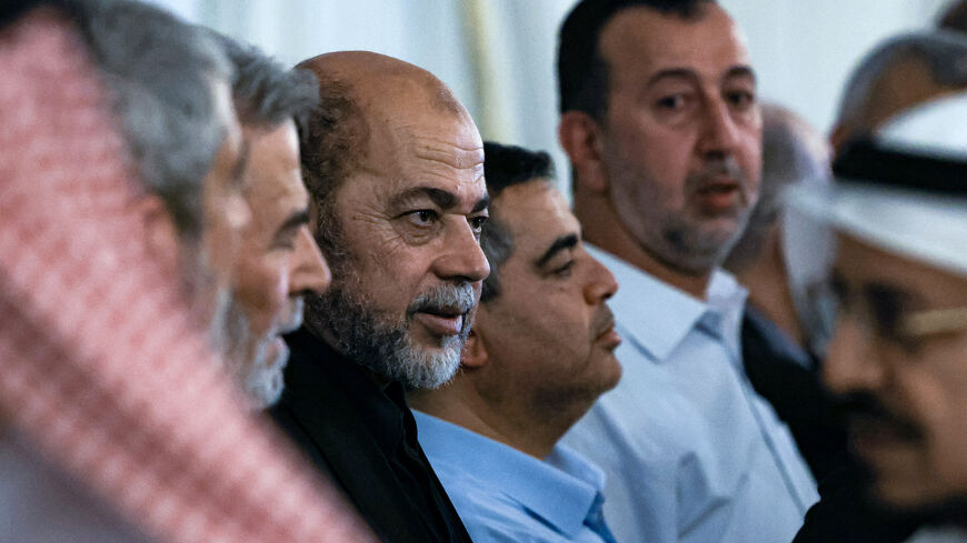 Mourners offer their condolences to senior member of Hamas' political bureau Musa Abu Marzuk (C) during the funeral of the slain Hamas political leader Ismail Haniyeh, in Doha on August 2, 2024. 