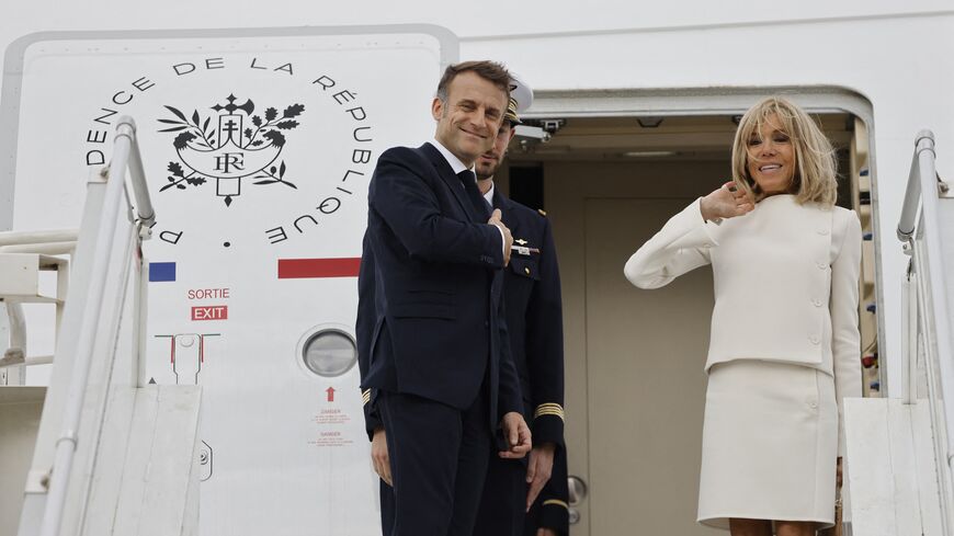 French President Emmanuel Macron and First Lady Brigitte Macron embark on an aircraft at the airport of Sale, north of Rabat, on Oct. 30, 2024.